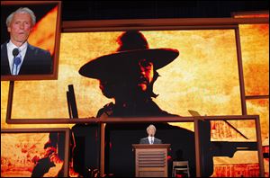 Actor Clint Eastwood, with a photo projected behind him of one of his characters from a western film, addresses the GOP convention in Tampa.