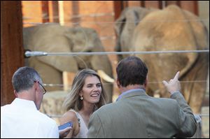 Lamont Thurston, of Toledo, left, and his wife Heather, center, listened to Toledo Zoo Deputy Director Ron Fricke talk about the zoo's elephants on the Tembo Trail at Feast with the Beasts at the Toledo Zoo.