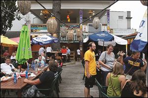 Dozens of people pack the patio of El Camino Real on a summer day.