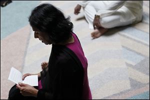 Jayashree Kunnathur reads a prayer during a worship service at the Hindu Temple and Heritage Hall.