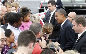 President Obama greets members of the crowd invited to welcome him at Toledo Express Airport. Mr. Obama, who landed at 7:12 p.m. Sunday, is to speak today at Scott High School in Toledo's Old West End.