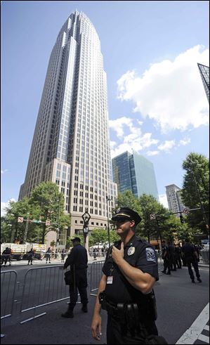An officer monitors an area near a protest in Charlotte. A group gathered Sunday ahead of Tuesday's start of the Democratic convention.