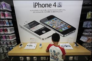 A boy checks an iPhone at an Apple booth at an electronic store in Tokyo. Several major tech companies are cramming product announcements into this holiday-shortened workweek. Nokia and Motorola Mobility, former leaders in the mobile race who are now also-rans, have scheduled events for Wednesday at which they are likely to unveil new smartphones. And the next day, Amazon is expected to introduce new Kindle devices.