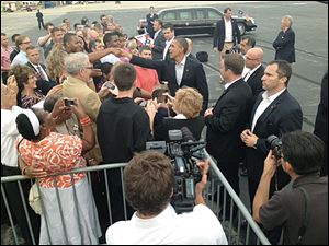 President Obama greets people Sunday night at Toledo Express Airport. The wheels touched down at 7:12 p.m.