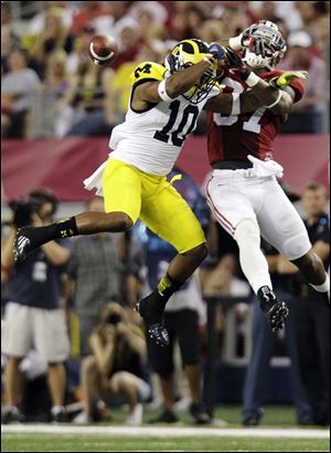Alabama defensive back Robert Lester breaks up a pass intended for Michigan wide receiver Jeremy Gallon.