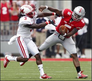 Ohio State quarterback Braxton Miller tries to get past Miami's Dayonne Nunley. Miller set an all-time record for Ohio State quarterbacks by rushing for 161 yards. He also threw for 207 yards and a pair of touchdowns.