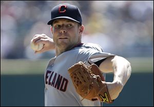 Cleveland Indians starting pitcher Corey Kluber throws against the Detroit Tigers in the first inning of a baseball game in Detroit.