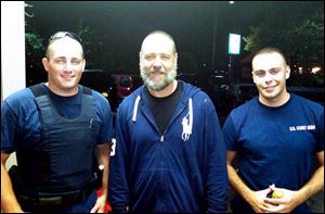 Actor Russell Crowe, center, with Coast Guard petty officers  Robert Swieciki, left,  and Thomas Watson Sunday.  Crowe and a friend became disoriented while kayaking in Long Island Sound Sunday and called the Coast Guard for assistance.  