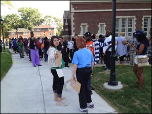 Priscilla Martinez, a field organizer with the Obama campaign, organizes the crowd in front of Scott High School hours before Mr. Obama is set to speak.