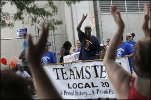 Supporters cheered the Teamsters Local 20 as they marched Monday morning during the Toledo Labor Day Parade. Hundreds of people turned out to see local unions, their supporters and other organizations march to celebrate American workers.
