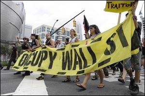 Occupy Demonstrators move through downtown in an unscheduled protest march, Tuesday.