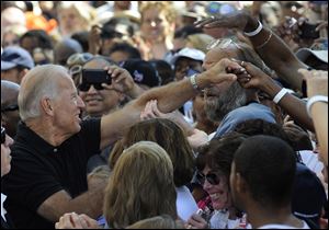 Vice President Joe Biden wades into a sea of supporters in Detroit after addressing a crowd outside the Westin Book Cadillac Hotel Monday during a campaign stop.