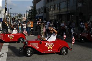 Representatives from Mecca Temple No. 43 ride along the parade route. Police estimated that about 10,000 lined downtown streets to watch the parade.