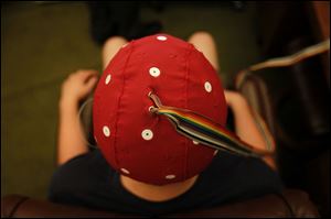 A patient demonstrates how the EEG cap is used to measure the brain's radiating energy.