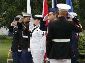 Marine Master Sgt. Steven Kosinski, right, and the Honor Guard salute during the annual Support the Troops Rally at Friendship
Park in the Point Place neighborhood of Toledo.