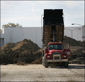 Dirt is dumped behind the former Showcase Cinemas on Secor Road in this 2010 file photo.