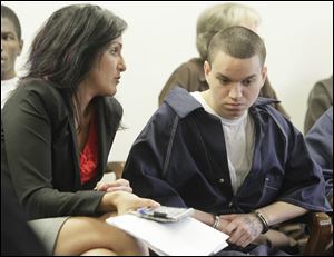 Attorney Nicole Khoury speaks with client Devon Daly in Lucas County Common Pleas Court. Daly received a 14-year prison sentence Thursday in the death of Rory Hunter.