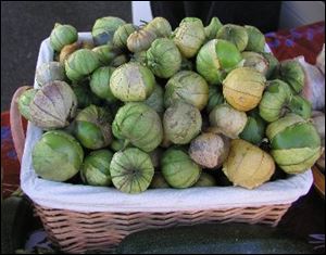 Tomatillos are green, rounded, tomato-like fruit enclosed in thin, papery husks.