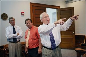 Common Pleas Judge Jack Puffenberger points out to Common Pleas Judge James Jensen, left, and Clerk Bernie Quilter areas of the Lucas County Courthouse that need attention and repair.