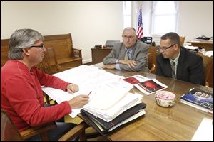 In a 2011 photo, architect Bruce Miller, left, meets with commissioners Don Regula, center, and Doug Spencer.