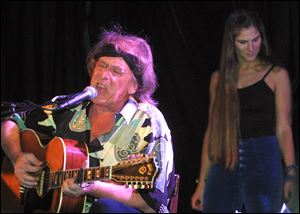 Jefferson Starship's Paul Kantner, left, performs in front of Diana Mangano during the 'Freedom Sings' benefit concert in New York in this June 20, 2001, file photo.