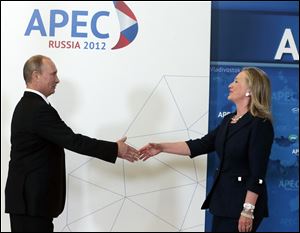 Russian President Vladimir Putin, left, meets U.S. Secretary of State Hillary Rodham Clinton on her arrival Saturday at the APEC summit in Vladivostok, Russia.