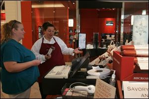 A customer shops at Hickory Farms' seasonal kiosk at Westfield Franklin Park in this 2008 file photo.