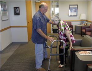 Barbara Streight is helped up by son Don Streight as she gets ready for her first follow-up visit.