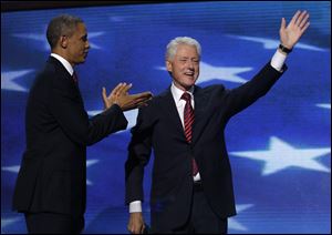 Former President Bill Clinton acknowledges the cheers as President Obama applauds after Mr. Clinton's speech at the Democratic National Convention. 