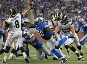 Detroit defensive lineman Nick Fairley closes in on St. Louis quarterback Sam Bradford. Fairley had one sack in the game, and the Lions recorded three sacks as a team in their victory over the Rams.