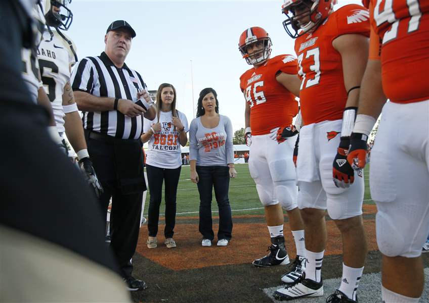 Bowling-Green-State-University-students-Kayla-Somoles-left-and-Angelica-Mormile-join-the-coin-toss