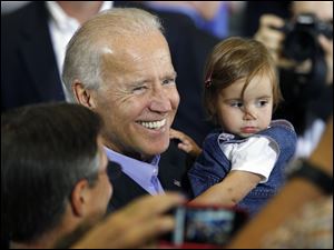 Vice President Joe Biden greets supporters, including a young one, at Milford High School near Cincinnati. He asserted GOP Medicare ideas would cost seniors.