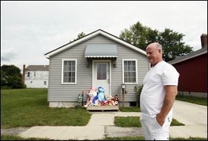 Robert Lynch, Heather Jackson’s uncle, pauses outside the scene of the triple homicide. Mrs. Jackson had lived in the house for only a short time but had decorated it to try to make it into a family home, friends said.