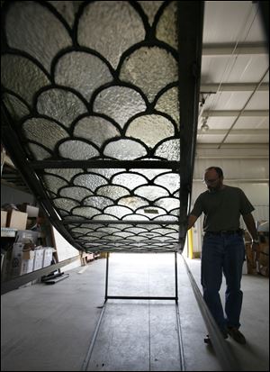 Reggie Buehrer, owner of Window Creations., Inc., near Ottoville, Ohio, talks about the restoration his company is performing on window panels from ceiling of the courtroom inside the Van Wert County Courthouse.