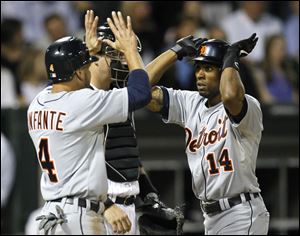 Detroit Tigers' Omar Infante (4) greets Austin Jackson at home after the pair scored on Jackson's  homer off Chicago White Sox starting pitcher Jake Peavy during the fifth inning of a baseball game Tuesday.