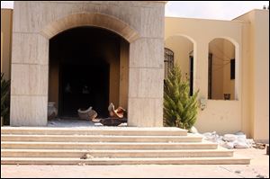 Soot and debris spills out of the U.S. Consulate after an attack by protesters angry over a film that ridiculed Islam's Prophet Muhammad in Benghazi, Libya. The U.S. ambassador to Libya and three other Americans were killed. 