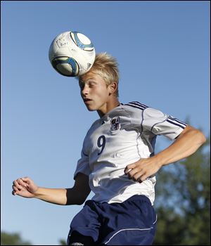 Archbold soccer player Brodie Nofziger connects on a header during practice.