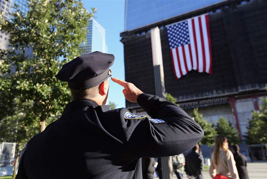 A-New-York-City-Police-officer-salutes-a-flag