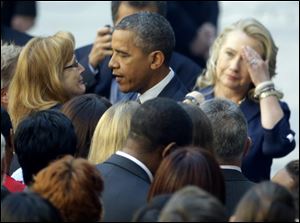 President Barack Obama, accompanied by Secretary of State Hillary Rodham Clinton, meets with State Department personnel Wednesday in the courtyard of the State Department in Washington.