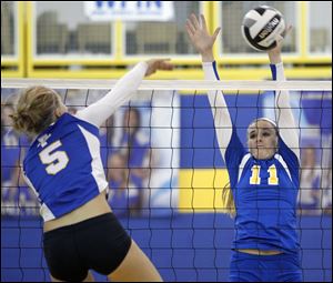 St. Ursula's Hannah Engler (11) defends against Findlay's Ciara Ralston on Thursday in Toledo. St. Ursula defeated Findlay in three game. 