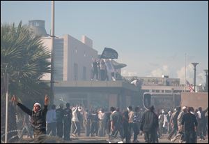 Protesters gather in front of the main entrance of the U.S. embassy in Tunis, Tunisia.