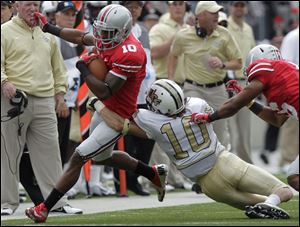 Ohio State's Corey Brown, left, turns upfield against Central Florida's Jordan Ozerities during the second quarter of last Saturday's game.