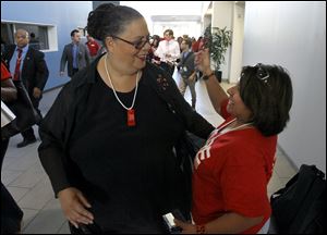 Karen Lewis, president of the Chicago teachers union, left, is greeted by a union member after her meeting with the union's House of Delegates. Lewis told the delegates that a 