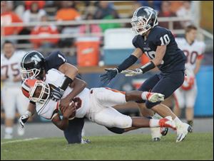 Napoleon's Nate Rohrs, takes down Southview's Keith Gilmore, after a pass reception Friday in Napoleon.