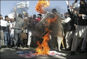 Afghans burn the U.S. flag in Herat, west of Kabul, Afghanistan, on Sunday during a protest against an Internet video mocking the Prophet Muhammad that many fear could further aggravate Afghan-U.S. relations. The video has sparked protests throughout the Muslim world and the Afghan government blocked the YouTube site that hosts the video and its parent company, Google Inc., over the weekend in a move to prevent violent protests.