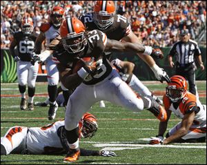 Trent Richardson leaves several Bengals sprawled on the field after scoring on a 23-yard pass play in the third quarter.