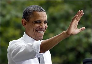 President Barack Obama waves to the crowd at a campaign event at Eden Parks Seasongood Pavilion, Monday in Cincinnati.