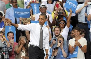 President Barack Obama waves to supporters after speaking at a campaign event at Schiller Park in Columbus, Ohio.