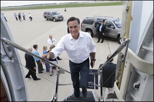 Republican presidential candidate and former Massachusetts Gov. Mitt Romney boards his campaign charter plane in Kansas City, Mo., after a refueling as he travels to Los Angeles, Sunday.