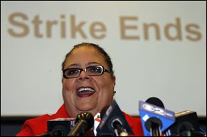 Karen Lewis, president of the Chicago Teachers Union smiles as she talks with reporters Tuesday after the union's House of Delegates voted to suspend the strike.